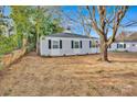 Charming single-story home featuring light gray siding, black shutters and manicured flower beds at 1008 Bose Ave, Rock Hill, SC 29732