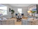 Bright living room featuring neutral walls, modern furnishings, and natural light from a large window at 1008 Bose Ave, Rock Hill, SC 29732