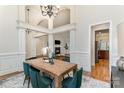 Open-concept dining room with natural light, modern chandelier, and views of the living room at 125 Whiterock Dr, Mount Holly, NC 28120