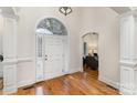 Elegant foyer with hardwood floors, white columns, and a view into the living area at 125 Whiterock Dr, Mount Holly, NC 28120
