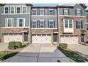 Charming townhome featuring a stone facade, three stories, and a one car garage at 1932 Catkin Ln, Charlotte, NC 28205
