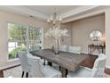 Dining room featuring a large window, modern chandelier, and seating for six at 2017 Bridleside Dr, Indian Trail, NC 28079