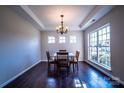 Well-lit dining room with a large window, chandelier, and seating for four at 2017 Bridleside Dr, Indian Trail, NC 28079
