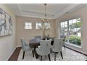 Bright dining room featuring a modern chandelier, ample natural light, and seating for six at 2017 Bridleside Dr, Indian Trail, NC 28079