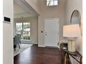 Bright foyer with hardwood floors and a large window letting in natural light, with a view to the dining area at 2017 Bridleside Dr, Indian Trail, NC 28079