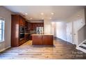 Open kitchen with stainless steel appliances, island, and hardwood flooring at 2017 Bridleside Dr, Indian Trail, NC 28079