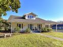 Charming home with a long, covered front porch and well-manicured landscaping at 214 W Elm St, Wingate, NC 28174