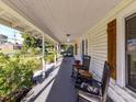 Inviting covered front porch features classic rocking chairs and views of the landscaped front yard at 214 W Elm St, Wingate, NC 28174