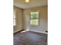 Cozy bedroom with natural light, fresh paint, and sleek flooring offers a comfortable retreat at 2207 Madrid St, Charlotte, NC 28216