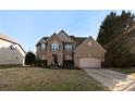 Inviting brick two-story home with a well-manicured lawn and an attached two-car garage at 2283 Iron Works Dr, Clover, SC 29710