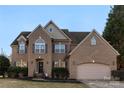 Attractive brick two-story home with a well-kept lawn and an attached two-car garage at 2283 Iron Works Dr, Clover, SC 29710