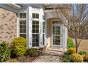 Up close view of the front door and bay window featuring well-maintained landscaping at 23072 Whimbrel Cir, Fort Mill, SC 29707