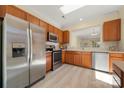 Modern kitchen with stainless steel appliances, granite countertops, and wood cabinetry at 23072 Whimbrel Cir, Fort Mill, SC 29707