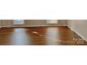 Spacious living room with gleaming hardwood floors and natural light from large windows at 2314 Knickerbocker Dr, Charlotte, NC 28212