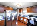Functional kitchen with wood cabinets, stainless steel refrigerator, and appliances at 237 Creekstone Ln, York, SC 29745