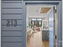 A view through the open doorway shows the kitchen island and living space with balcony beyond at 2401 Euclid Ave # 213, Charlotte, NC 28203