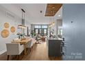 A view through the open doorway shows the dining and living space with balcony beyond at 2401 Euclid Ave # 213, Charlotte, NC 28203
