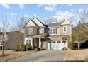 Two-story home featuring brick accents, a two-car garage, well-maintained landscaping, and a basketball hoop on the driveway at 241 Catoctin Rd, Rock Hill, SC 29732