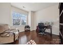 Bright office with hardwood floors, a large window, a work desk setup, and a cozy chair, perfect for remote work at 241 Catoctin Rd, Rock Hill, SC 29732