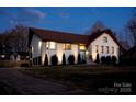 An elegant home with a white brick facade, manicured landscaping, and a welcoming entrance at 241 Spring Run Dr, Mooresville, NC 28117