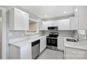 Modern kitchen featuring sleek white cabinets, stainless steel appliances, and bright countertops at 2529 Grimes St, Charlotte, NC 28206