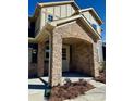 A charming front porch with stone pillars and a welcoming entrance create an inviting feel at 2534 Crimson Way, Monroe, NC 28112