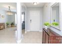 Inviting foyer with neutral tile flooring, arched entryways, and a view into the living area at 2627 Bridgeville Ln, Charlotte, NC 28262