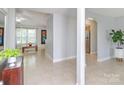 Open-concept foyer with neutral tile, arched doorways, and a view into the adjacent dining and living areas at 2627 Bridgeville Ln, Charlotte, NC 28262
