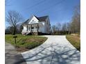 A white two-story home with a long concrete driveway and a covered front porch at 320 City Ave, Lancaster, SC 29720