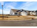 A well-maintained home with a manicured lawn and attached two-car garage at 324 Aniston Ln, Shelby, NC 28152