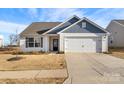 Charming single-story home with a two-car garage and well-maintained front lawn at 324 Aniston Ln, Shelby, NC 28152