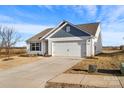 Single-story home with a well-manicured lawn and spacious driveway at 324 Aniston Ln, Shelby, NC 28152