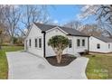 Cozy bungalow with a freshly paved driveway, white siding, and a well-kept yard at 345 Grice St, Shelby, NC 28150