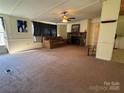 Open-concept living room with fireplace and lots of natural light at 4946 A Tinkers Creek Rd, Edgemoor, SC 29712