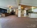 Spacious living room featuring a stone fireplace and comfortable seating area at 4946 A Tinkers Creek Rd, Edgemoor, SC 29712