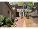 Attractive home exterior featuring a brick walkway and manicured landscaping leading to the entrance at 5306 Wingedfoot Rd, Charlotte, NC 28226