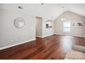 Open concept living room features wood floors, vaulted ceiling and partial view to the kitchen at 544 Castlewood Cir, Rock Hill, SC 29730