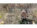 High angle of well maintained townhouses with well manicured front yards and a bare tree at 582 Sixth Baxter Xing, Fort Mill, SC 29708