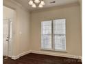 This well-lit dining room features elegant hardwood floors, large windows, and modern lighting fixture at 5905 Waverly Lynn Ln, Charlotte, NC 28269