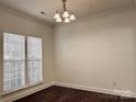 This well-lit dining room features elegant hardwood floors, large windows, and modern lighting fixture at 5905 Waverly Lynn Ln, Charlotte, NC 28269