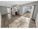 Inviting living room featuring sleek hardwood floors and natural light through sliding glass doors to the yard at 7140 Stonington Ln, Charlotte, NC 28227