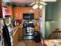 Efficient kitchen with stainless steel appliances, wooden cabinets, and functional layout at 7426 Riding Trail Rd, Charlotte, NC 28212