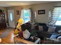 Inviting living room with hardwood floors, large window, and comfortable seating area at 7426 Riding Trail Rd, Charlotte, NC 28212