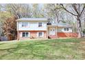 Charming two-story home with brick accents and a well-manicured front lawn at 7515 Riding Trail Rd, Charlotte, NC 28212