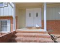 Welcoming front entrance with double doors, brick steps, and classic architectural details at 7515 Riding Trail Rd, Charlotte, NC 28212