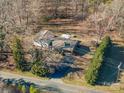 Aerial view of home with beautiful landscaping, long driveway, mature trees, and carport at 8080 Monbo Rd, Catawba, NC 28609