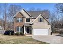 Traditional two-story home with brick and siding, a well-maintained lawn, and an attached two-car garage at 8822 Crape Myrtle Dr, Stanfield, NC 28163