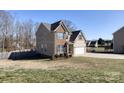 Inviting two-story home with brick and siding details, a backyard, and an attached two-car garage at 8822 Crape Myrtle Dr, Stanfield, NC 28163