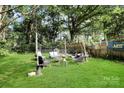 Inviting backyard with outdoor seating, a fire pit, and string lights for cozy gatherings at 908 Dogwood Dr, Gastonia, NC 28054