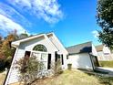 Well-maintained home featuring white siding, black shutters, and a manicured lawn at 9513 Isaac Hunter Dr, Charlotte, NC 28214